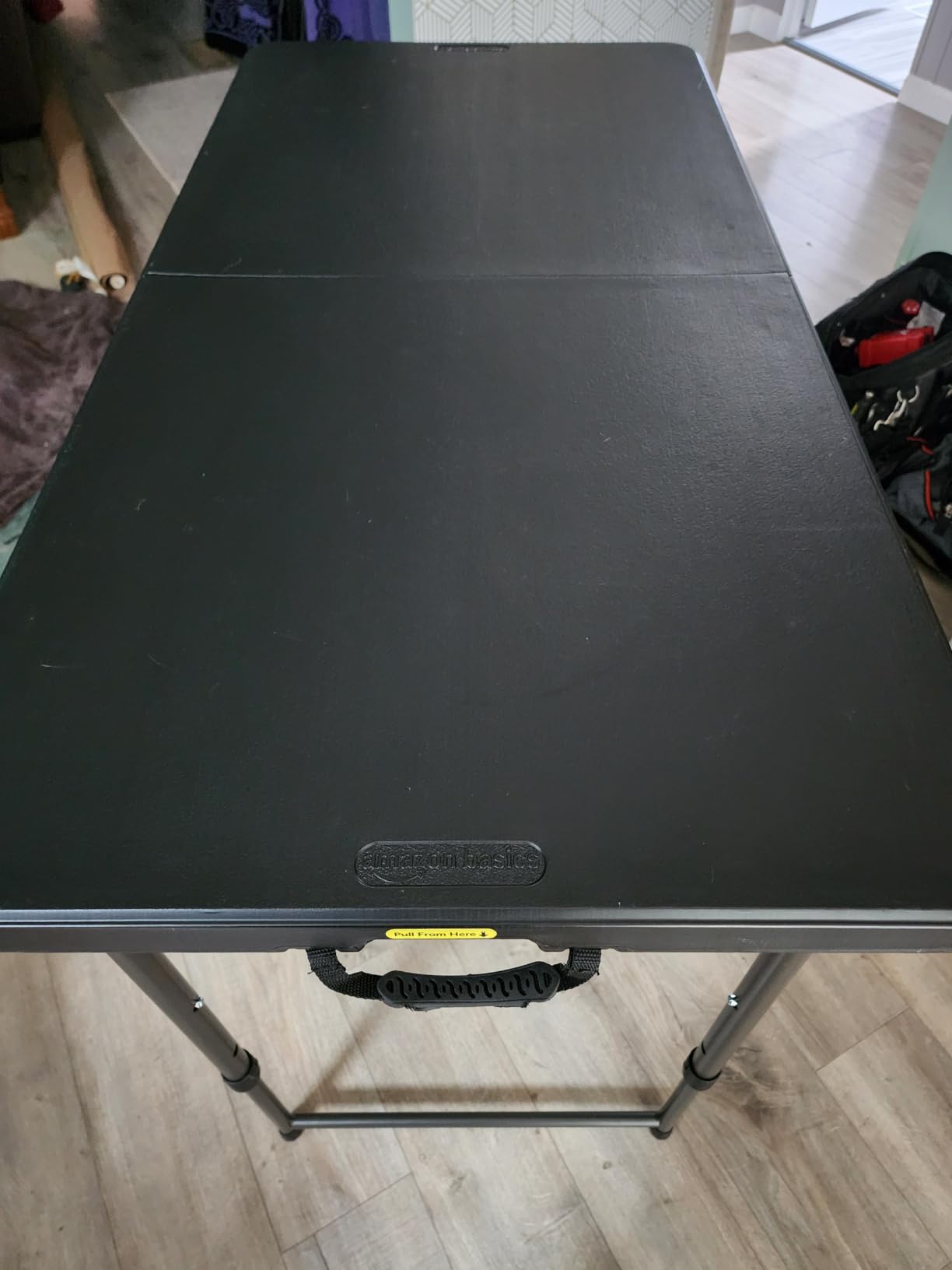 Amazon Basics Portable 4 Ft Rectangular Folding Dining Table, 4 Adjustable Height Settings, Space Saving Fold-in-Half Design and Carrying Handle, Indoor & Outdoor, Washed Black, 47.8 x 23.9 x 33.9 in customer photo 1